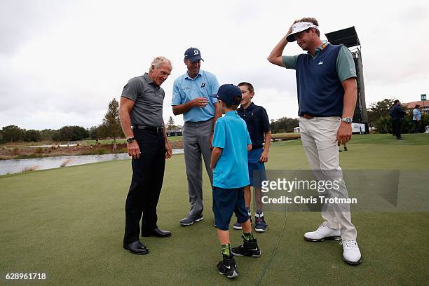 Greg Norman chats with the Matt Kuchar, Cameron Kuchar, Carson Kuchar and Harris English following their victory after the final round of the...