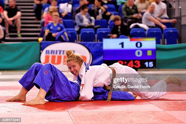 Kelly Petersen-Pollard of Hardy Spicer JC smiles broadly as she holds Shelley Ludford of Osaka JC to win the gold medal and relegate Ludford to the...