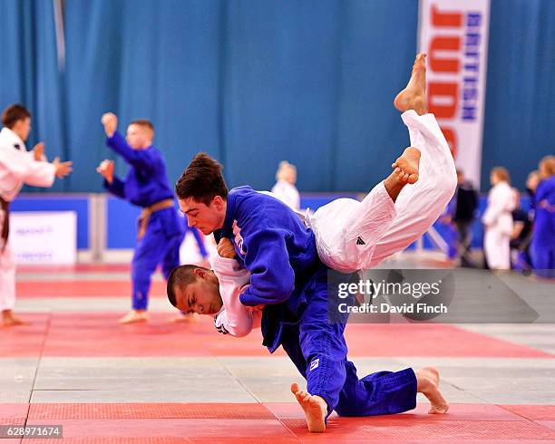Edgar Polovinkins of Ernest Bevin JC throws Jake Wingrove of Windsor JC for an ippon to win their u81kg Round One contest during the 2016 British...
