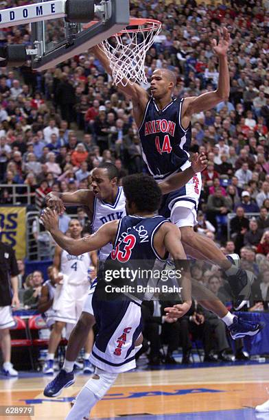 Richard Jefferson of Arizona and Jason Williams of Duke get tangled up on a play to the basket during the NCAA National Championship Game of the...