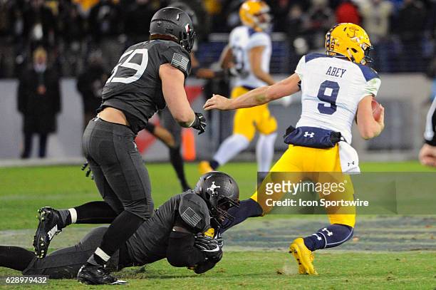 Navy Midshipmen quarterback Zach Abey is brought down by Army Black Knights linebacker Andrew King in the third quarter on December 10, 2016 at M&T...