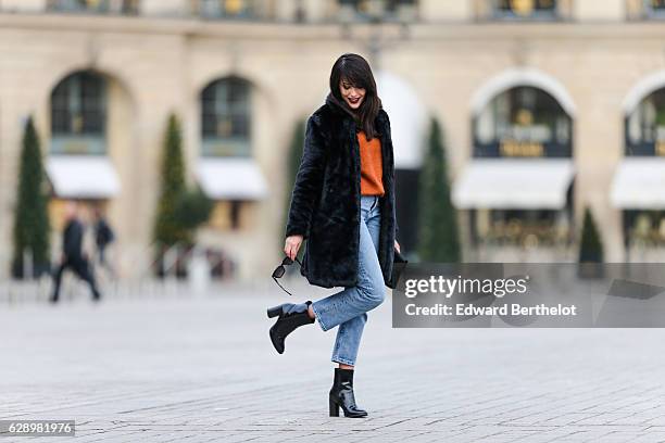 Sarah Benziane, fashion and life style blogger @lescolonnesdesarah, is wearing a New Look faux fur black coat, a New Look orange pull over, New Look...