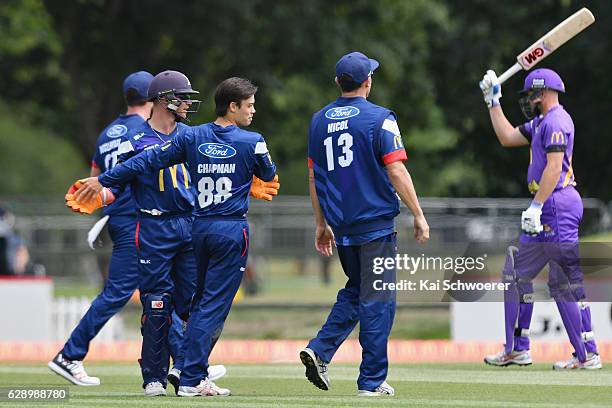 Mark Chapman of the Aces is congratulated by team mates after dismissing Peter Fulton of the Kings during the Super Smash Twenty20 match between the...