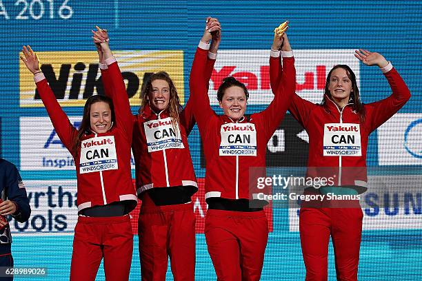 Team Canada celebrates their gold medal in the 4x200m Freestyle on day five of the 13th FINA World Swimming Championships at the WFCU Centre on...