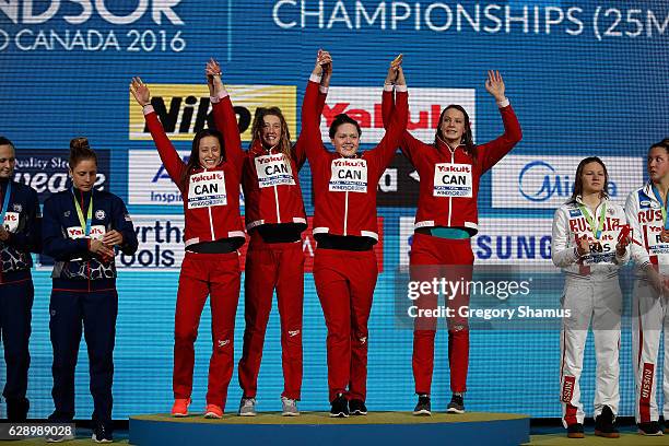 Team Canada celebrates their gold medal in the 4x200m Freestyle on day five of the 13th FINA World Swimming Championships at the WFCU Centre on...