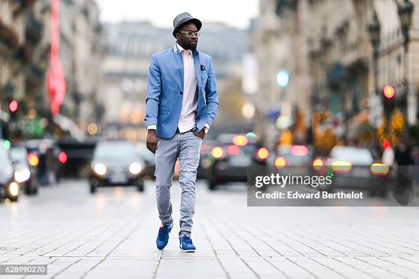 Sidya Sarr, fashion and life style blogger @theparisian, is wearing a Zara blue jacket, a Zara hat, an Andreas Osten watch, Nike Cortez blue shoes,...