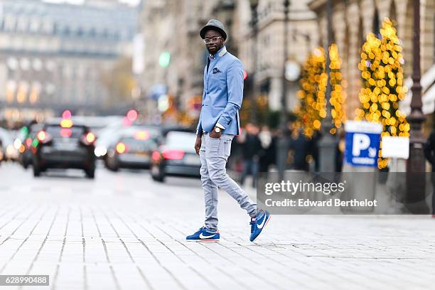 Sidya Sarr, fashion and life style blogger @theparisian, is wearing a Zara blue jacket, a Zara hat, an Andreas Osten watch, Nike Cortez blue shoes,...