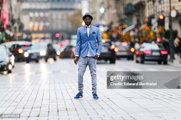 Sidya Sarr, fashion and life style blogger @theparisian, is wearing a Zara blue jacket, a Zara hat, an Andreas Osten watch, Nike Cortez blue shoes,...