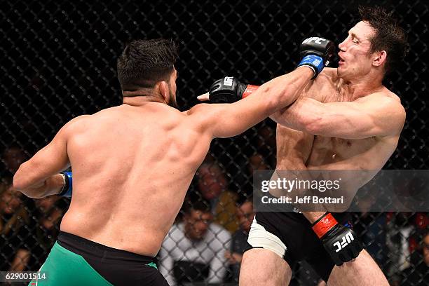 Kelvin Gastelum punches Tim Kennedy in their middleweight bout during the UFC 206 event inside the Air Canada Centre on December 10, 2016 in Toronto,...