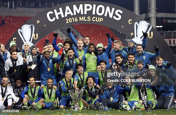 Seattle Sounders celebrate their MLS Cup final victory over Toronto FC at BMO Field on December 10, 2016 in Toronto. / AFP / Cole Burston