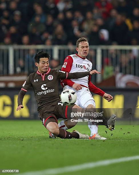 Ryo Miyaichi of St.Pauli and Marcel Gaus of Kaiserslautern battle for the ball during the Second Bundesliga match between FC St. Pauli and 1. FC...