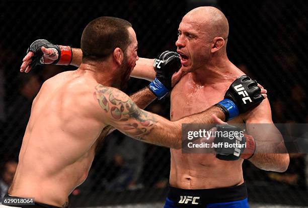 Opponents Donald Cerrone and Matt Brown hug at the start of the third and final round in their welterweight bout during the UFC 206 event inside the...