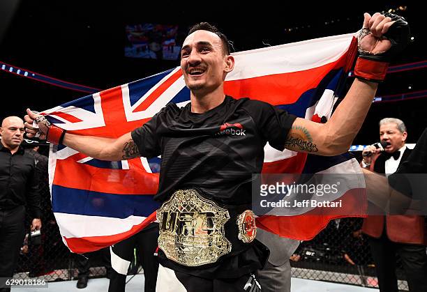 Max Holloway celebrates his TKO victory over Anthony Pettis in their interim UFC featherweight championship bout during the UFC 206 event inside the...