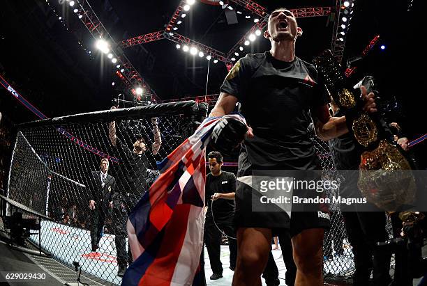 Max Holloway celebrates his victory over Anthony Pettis in their interim UFC featherweight championship bout during the UFC 206 event inside the Air...