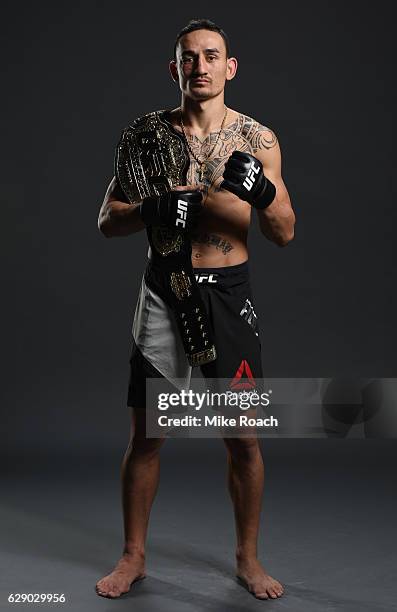 Max Holloway poses for a portrait backstage after his victory over Anthony Pettis during the UFC 206 event inside the Air Canada Centre on December...