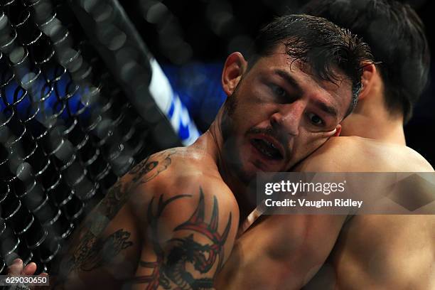 Doo Ho Choi of South Korea fights Cub Swanson of the United States in their Featherweight bout during the UFC 206 event at Air Canada Centre on...