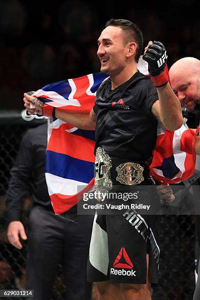 Max Holloway of the United States defeats Anthony Pettis of the United States for the Interim Featherweight Title during the UFC 206 event at Air...