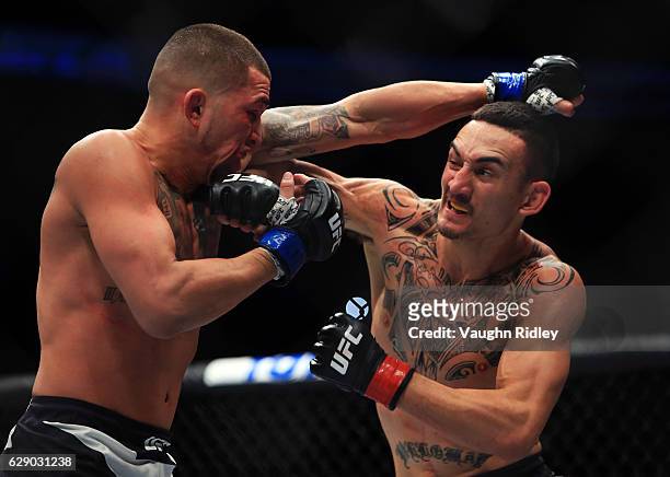 Max Holloway of the United States fights Anthony Pettis of the United States for the Interim Featherweight Title during the UFC 206 event at Air...
