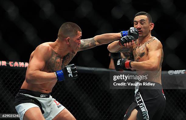 Max Holloway of the United States fights Anthony Pettis of the United States for the Interim Featherweight Title during the UFC 206 event at Air...