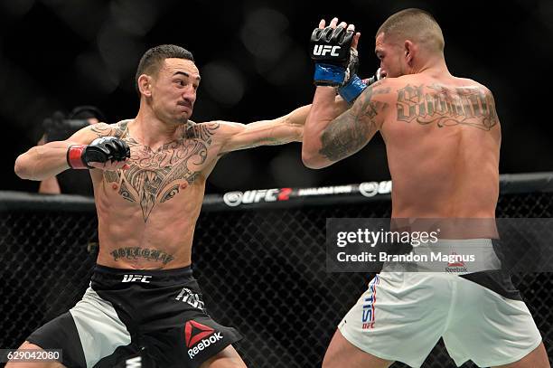 Max Holloway punches Anthony Pettis in their interim UFC featherweight championship bout during the UFC 206 event inside the Air Canada Centre on...