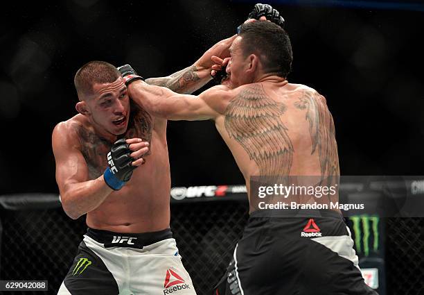 Max Holloway punches Anthony Pettis in their interim UFC featherweight championship bout during the UFC 206 event inside the Air Canada Centre on...