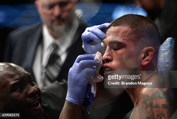 Anthony Pettis is checked by his corner in-between rounds while facing facing Max Holloway in their interim UFC featherweight championship bout...
