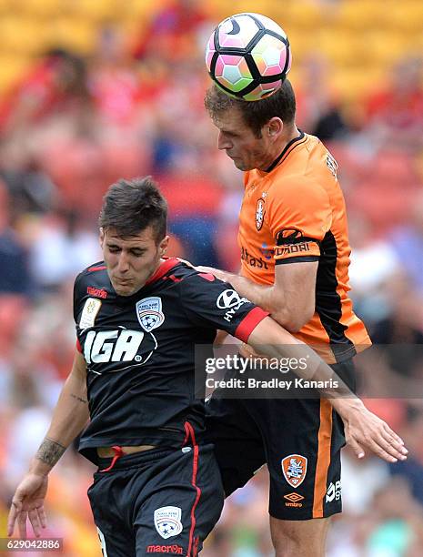 Luke DeVere of the Roar and Sergio Guardiola of Adelaide challenge for the ball during the round 10 A-League match between the Brisbane Roar and...