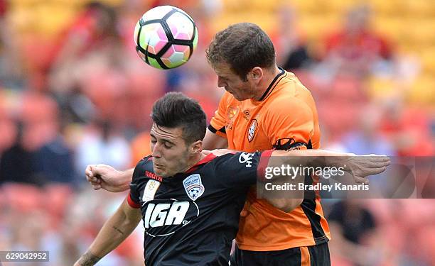 Luke DeVere of the Roar and Sergio Guardiola of Adelaide challenge for the ball during the round 10 A-League match between the Brisbane Roar and...