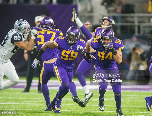 Emmanuel Lamur and Justin Trattou of the Minnesota Vikings run downfield on a punt play during an NFL game against the Dallas Cowboys at U.S. Bank...