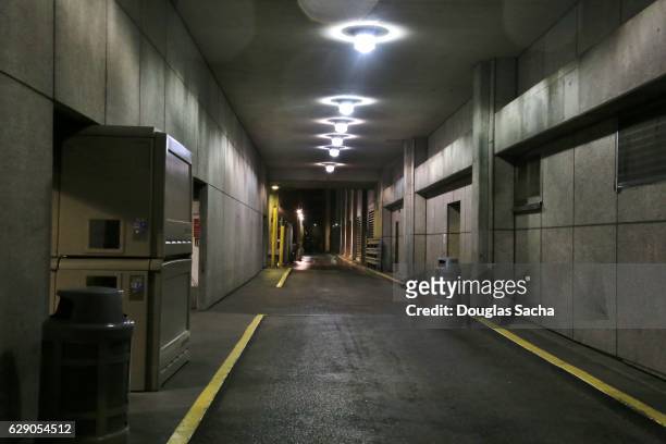vehicle access tunnel in underground parking garage - bunker stock pictures, royalty-free photos & images