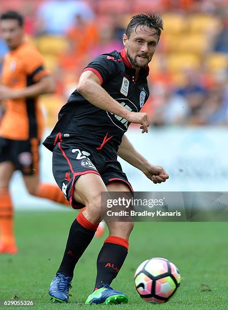 James Holland of Adelaide passes the ball during the round 10 A-League match between the Brisbane Roar and Adelaide United at Suncorp Stadium on...