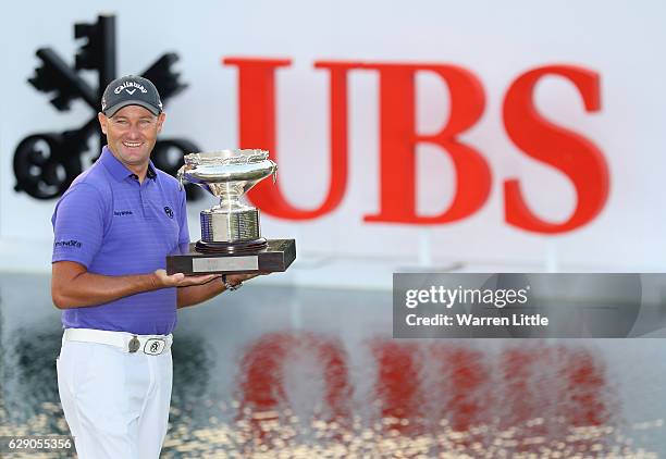 Sam Brazel of Australia poses with the trophy after winning the UBS Hong Kong Open at The Hong Kong Golf Club on December 11, 2016 in Hong Kong, Hong...