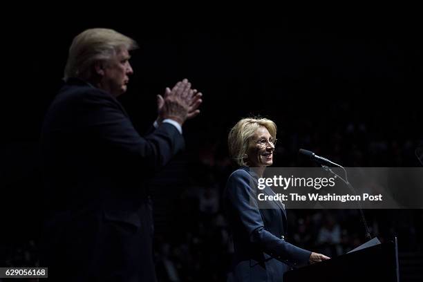 President-Elect Donald J. Trump listens as Betsy DeVos speaks at a "USA Thank You Tour 2016" event at the DeltaPlex in Grand Rapids, Mi. On Friday,...