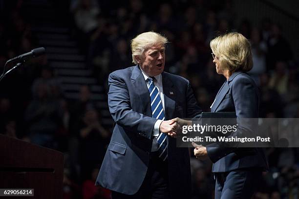 President-Elect Donald J. Trump and Betsy DeVos greet each other as they speak at a "USA Thank You Tour 2016" event at the DeltaPlex in Grand Rapids,...