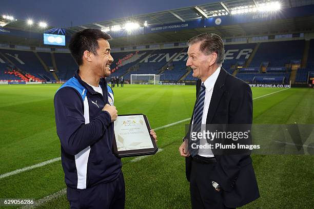Shinji Okazaki of Leicester City is presented with the AFC Asian International player of the year 2016 award by Andy Roxburgh the Asian Football...