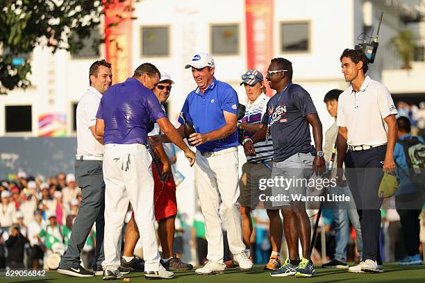 Sam Brazel of Australia is sprayed with champagne by Scott Hend of Australia and Rafa Cabrera Bello of Spain after winning the UBS Hong Kong Open at...