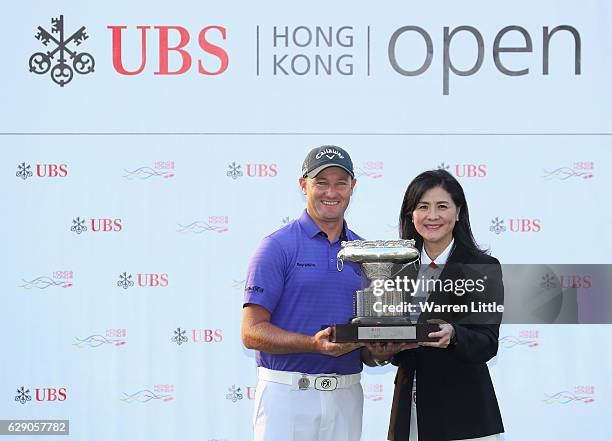 Sam Brazel of Australia is awared the trophy by Amy Lo, Head of Greater China, UBS after winning the UBS Hong Kong Open at The Hong Kong Golf Club on...