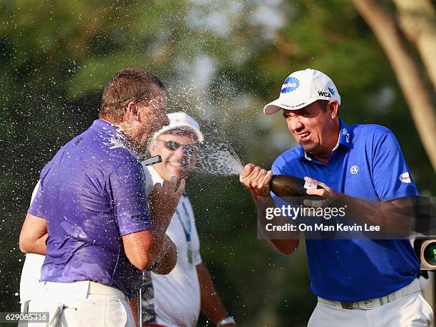 Scott Hend of Australia sprays champagne on Sam Brazel of Australia after he won the final round of 2016 UBS Hong Kong Open at The Hong Kong Golf...