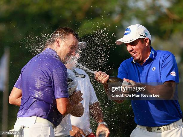 Scott Hend of Australia sprays champagne on Sam Brazel of Australia after he won the final round of 2016 UBS Hong Kong Open at The Hong Kong Golf...