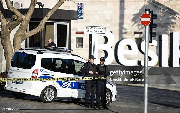 Turkish riot policemen stand guarded in front of the blast scene the day after an explosion at the Vodafone Arena Stadium on December 11, 2016 in...