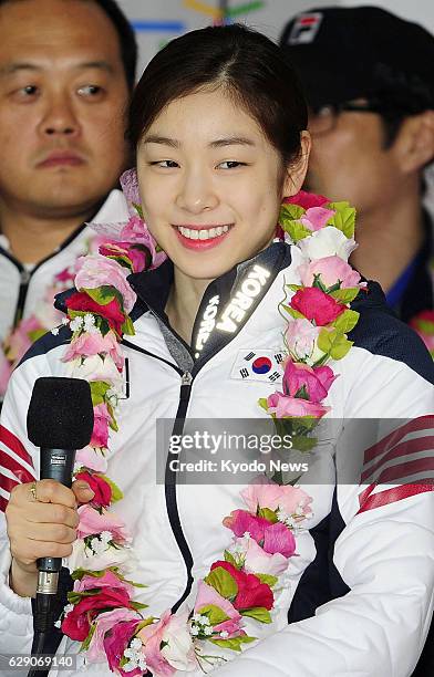 Incheon, South Korea - Sochi Winter Olympics women's figure staking silver medalist Kim Yu Na of South Korea meets reporters upon her arrival at...