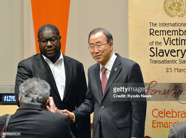 United States - British film director Steve McQueen and U.N. Secretary General Ban Ki Moon pose for photos on the occasion of the screening of "12...