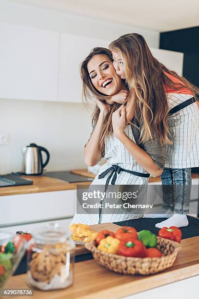 i love you mom! - mother and daughter kissing stock pictures, royalty-free photos & images