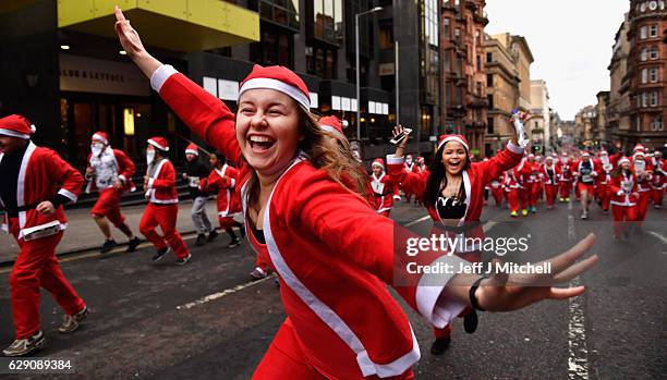 Over seven thousands of members of the public dressed as Santas make their way up St Vincent Street on December 11, 2016 in Glasgow, Scotland. The...