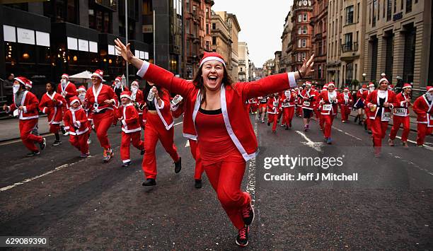 Over seven thousands of members of the public dressed as Santas make their way up St Vincent Street on December 11, 2016 in Glasgow, Scotland. The...