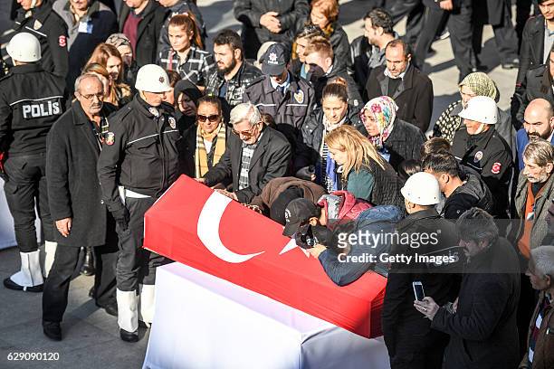 Relatives cry over the coffin of a police officer killed in yesterday's blast on December 11, 2016 in Istanbul, Turkey. According to Interior...