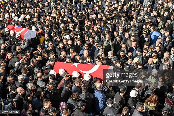 People carry the flag-draped coffins of police officers killed in yesterday's blast on December 11, 2016 in Istanbul, Turkey. According to Interior...