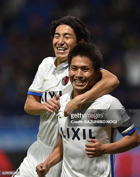 Kashima Antlers midfielder Yasushi Endo celebrates his goal with teammate Mu Kanazaki during the Club World Cup football match between Kashima...