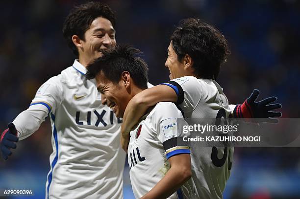 Kashima Antlers midfielder Yasushi Endo celebrates his goal with teammates during the Club World Cup football match between Kashima Antlers and...