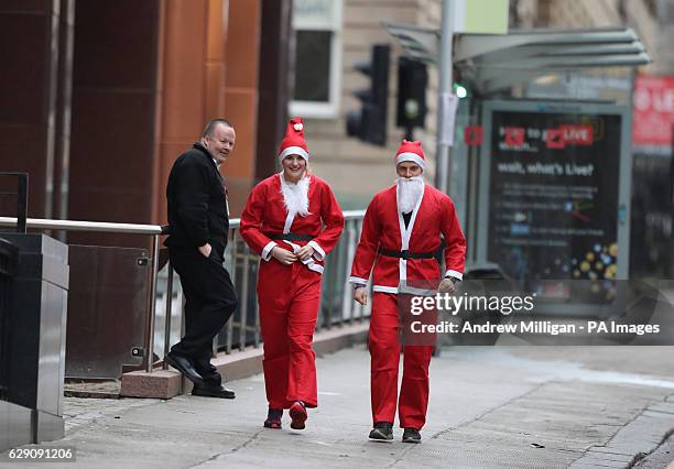 Runners in Santa costumes take part in the Glasgow Santa Dash to raise funds for the Beatson Cancer Charity.